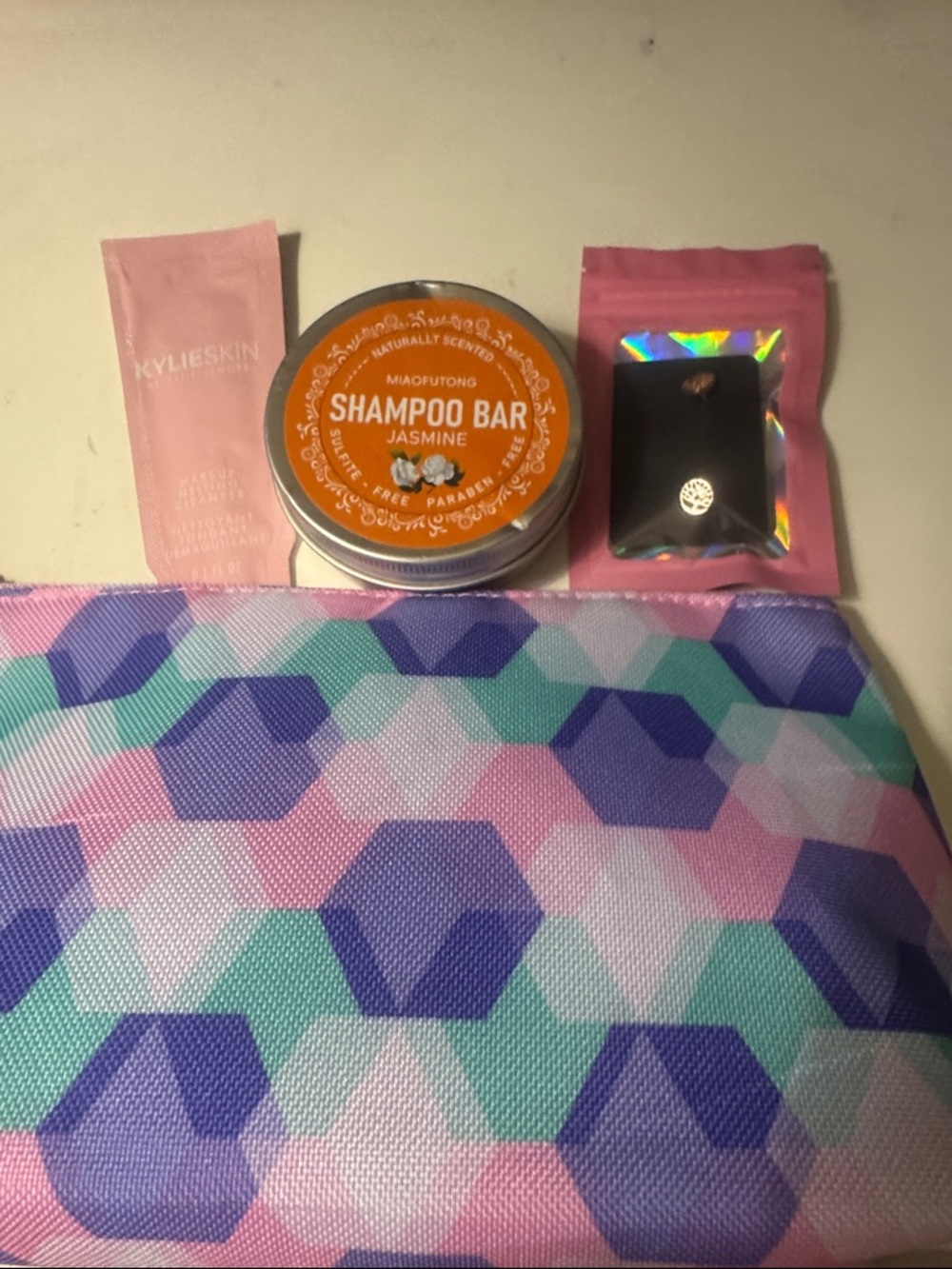 Clinique Cosmetic Bag with Geometric Pattern, Jasmine Shampoo Bar, Tree Earrings